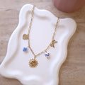collier été à charm's à breloque thème bleu et doré soleil coeur noeud fleur perle céramique acier inoxydable collier tendance